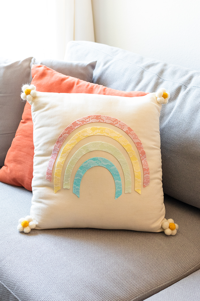 Rainbow pillow styled on a couch